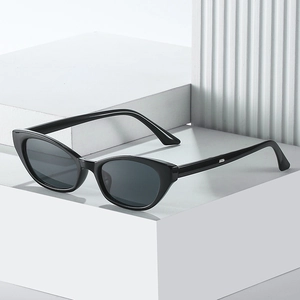 Classic black cat-eye sunglasses with resin frame and dark lenses on geometric props