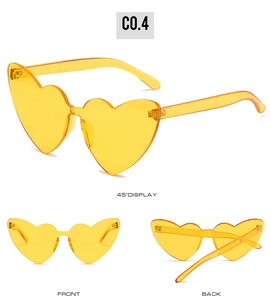 Trois vues de lunettes de soleil jaunes sans monture en forme de cœur: face, dos et angle 45°