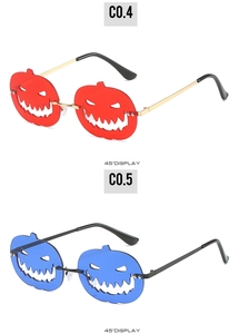 Detail view of Halloween pumpkin sunglasses with metal frames and colored cut-out lenses