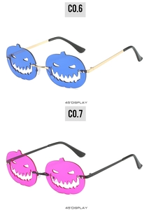 Detail view of pumpkin-shaped Halloween sunglasses in blue and pink at a 45-degree angle