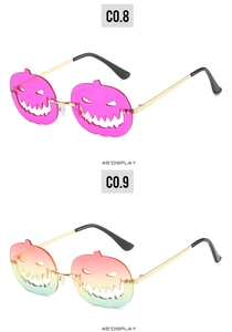 Detail of Halloween pumpkin shaped sunglasses in rose pink and orange green gradient colors
