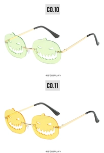 Detail of green and yellow pumpkin sunglasses with hollow face design and gold temples