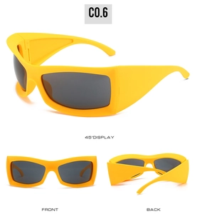 Detail view of bright yellow sporty sunglasses with wide frame and dark grey lenses