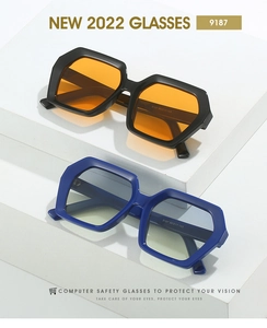 Close-up of geometric polygon sunglasses frames with colorful lenses on a clean podium