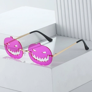 Pink pumpkin-shaped Halloween sunglasses with gold metal frame and镂空 lens design