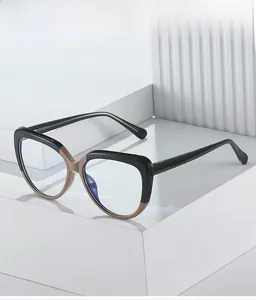 Detail of dual-tone cat-eye frame with anti-blue light lenses on geometric props