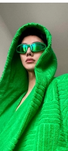 Detailed shot of neon green sports sunglasses and textured 3D embossed knit hoodie