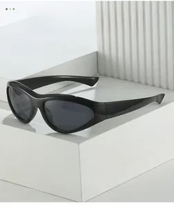 Close-up of black sports wrap sunglasses with sleek cat-eye frame on white geometric steps