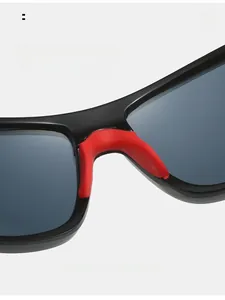 Macro detail of red soft rubber nose pads on black cycling sunglasses for comfort