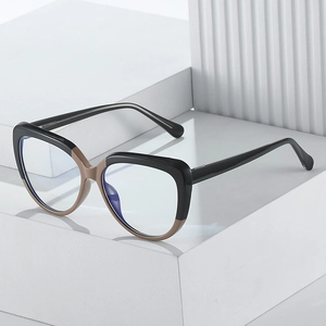 Chic cat-eye blue light blocking glasses with black and brown two-tone frame on stone