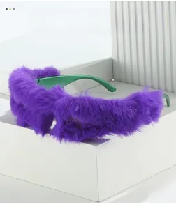 Detail of plush purple faux fur texture and green temple on oversized sunglasses