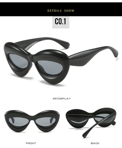 Three-view perspective of black inflated cat-eye sunglasses with thick frame design