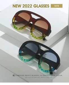 Detail view of dual-beam oversized square sunglasses in tortoise shell and black frames