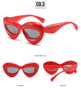 Multi-angle views of bright red cat-eye sunglasses with unique irregular wavy frames