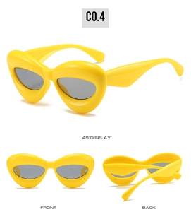 Three-way view of bold yellow cat-eye sunglasses with grey lenses and chunky frames