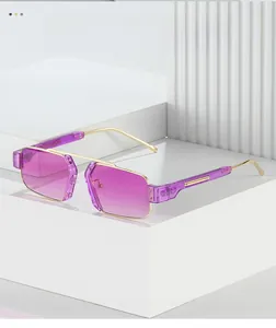 Detail of square gold metal sunglasses featuring purple gradient lenses on geometric stands
