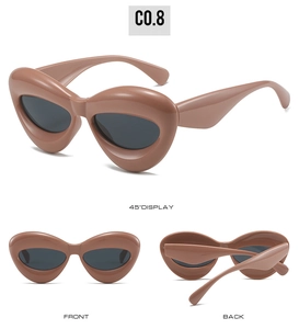 Detailed views of heart-shaped cat-eye sunglasses in puffed dusty pink frames and gray lenses