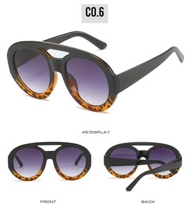 Detail view of large frame sunglasses featuring black and leopard print double bridge