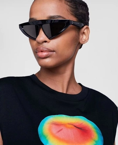 Close-up of black geometric triangle sunglasses with bold thick temples and logo detail