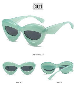 Three-angle view of mint green cat-eye heart sunglasses with dark grey lenses