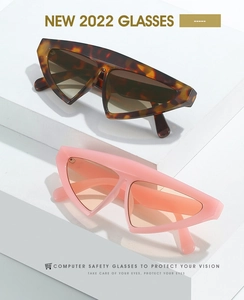 Detail view of modern geometric triangle sunglasses with tortoiseshell and pink frames