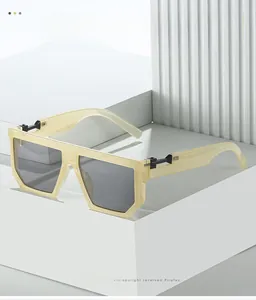 Detail of cream oversized square sunglasses with dark grey lenses on geometric stand