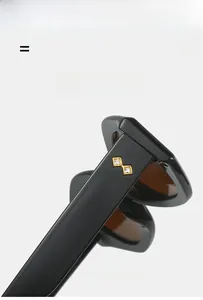 Detail of black glossy temple with golden crystal accents on sleek fashion sunglasses