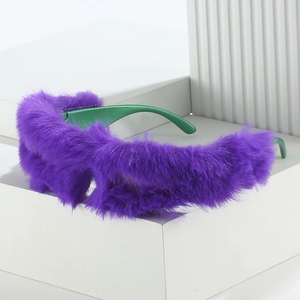 Plush purple faux fur sunglasses with bold green temples on a minimalist white stand