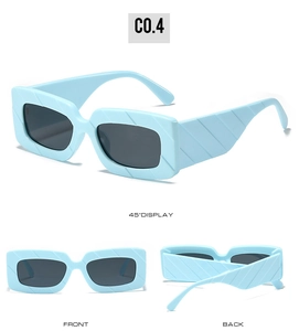 Detail view of light blue thick square sunglasses featuring diagonal textured frame patterns