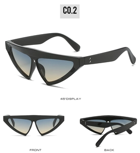 Close-up of triangle cat-eye sunglasses with gradient lenses and metal dot details