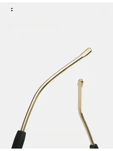 Detail view of gold metal curved sunglasses temples with black tips for comfort