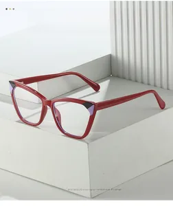 Red cat-eye TR90 frames featuring unique black and purple geometric accents on white plinth