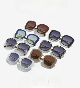 Flat lay of square oversized sunglasses in various colors with gradient lenses