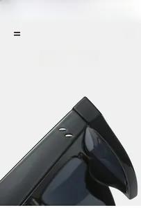 Detail view of glossy black triangular sunglasses frame with iconic metal rivets