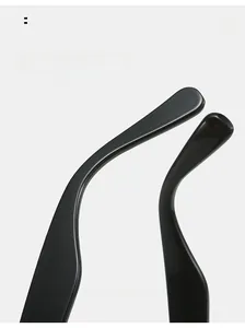 Close-up of curved ergonomic mirror legs on glossy black triangle sunglasses