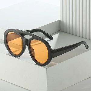 Retro oversized sunglasses featuring black frames and orange lenses on geometric pedestals