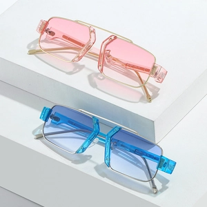 Fashionable square metal sunglasses with gradient blue and pink lenses on white blocks