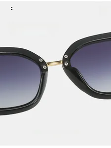 Detailed macro view of square frame sunglasses with gold metal bridge and soft nose pads