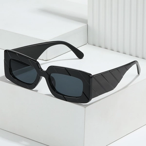 Classic black square sunglasses with textured frames on a minimalist white display