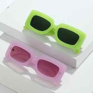 Neon green and light purple square sunglasses set on white geometric stairs