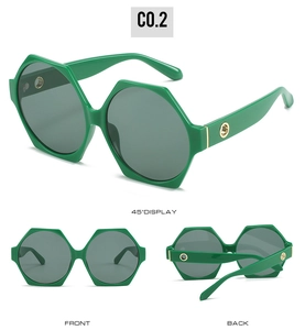 Detailed view of green hexagonal sunglasses with gold hinge accents and grey lenses