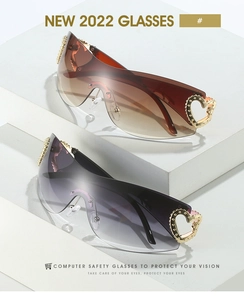 Detail of oversized rimless sunglasses with gold heart rivets on brown and purple lenses