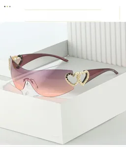 Close-up of Y2K rimless wrap sunglasses with gradient purple lenses and gold heart hinges