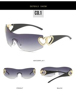 Detail of rimless Y2K sunglasses featuring gold heart accents and purple gradient lenses