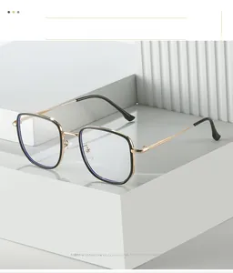 Detail showing modern square metal glasses frame with black and gold textured finish