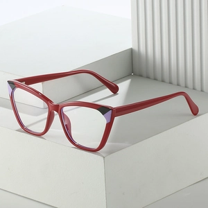 Cat eye red TR90 glasses frames with bicolor temple tips on white geometric background