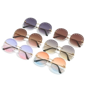 Lunettes de soleil rondes sans monture avec verres dégradés et détails ajourés