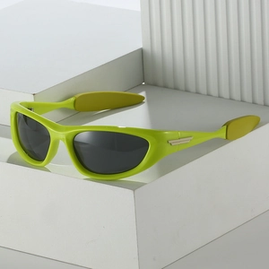 Polarized neon green sports sunglasses with cat-eye frame and gold metal wing detail