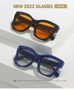 Close-up of modern square sunglasses with orange and blue lenses on minimalist stand