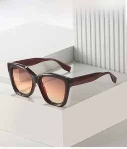 Close-up of deep red square frame sunglasses with orange gradient lenses on white display
